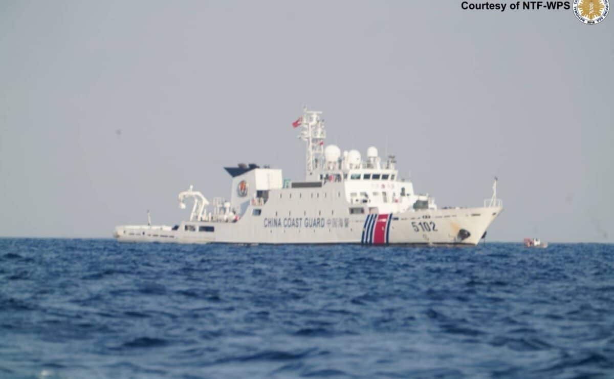 A Chinese Coast Guard vessel is seen as personnel from the Philippine Navy, Coast Guard and Police Maritime Group conduct a maritime operation at Pag-asa Cay on Sunday. — Photo from the National Task Force-West Philippine Sea