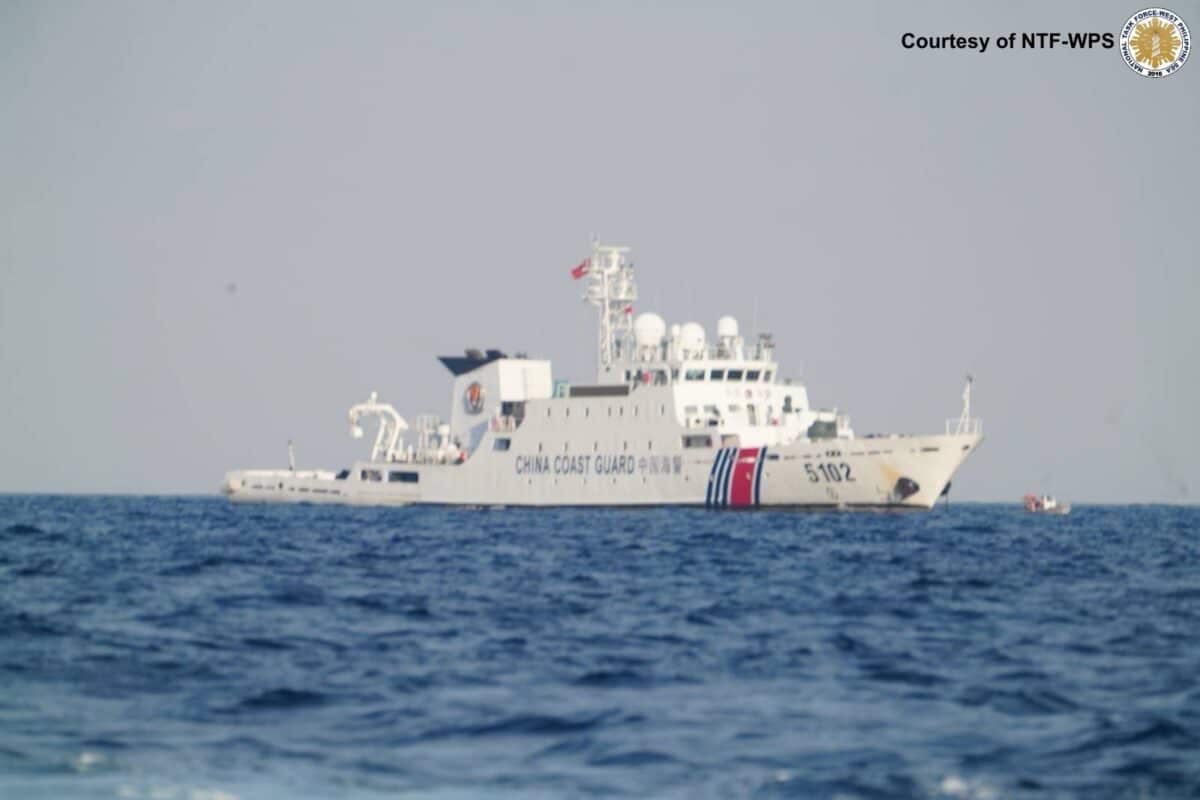 A Chinese Coast Guard vessel is seen as personnel from the Philippine Navy, Coast Guard and Police Maritime Group conduct a maritime operation at Pag-asa Cay on Sunday. — Photo from the National Task Force-West Philippine Sea
