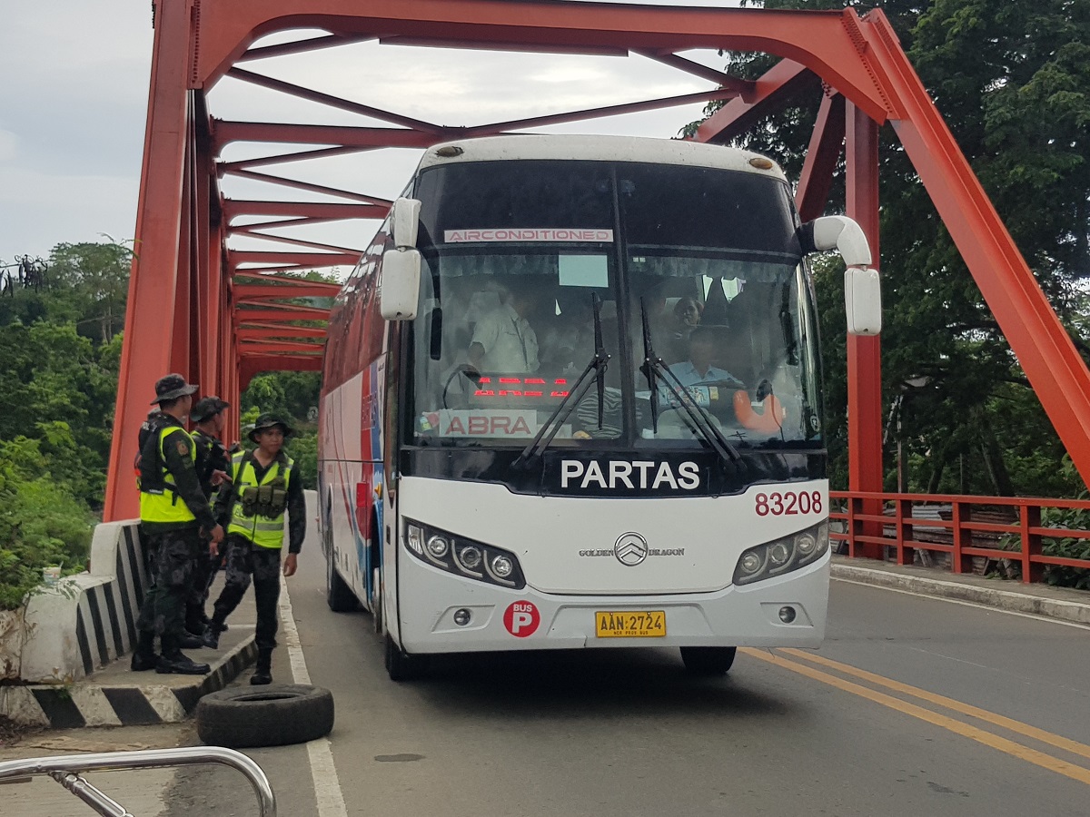 ROAD CHECK In this 2019 photo, police officers in Bangued,Abra, check a passenger bus as security measures were put in
place during the election period that year.